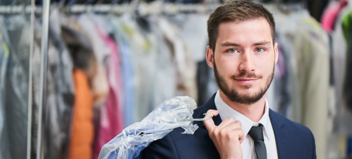 Man Smiles While Holding Dry Cleaning Min Min