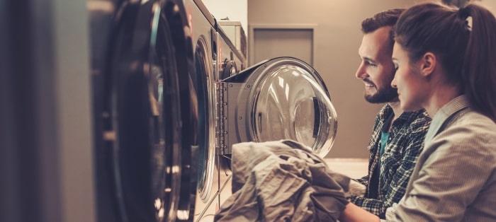 Couple Loading Washing Machine Min